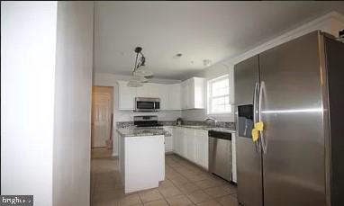 11809 Old Fort Road Fort Washington, MD 20744 - Photo 2 of 21 a kitchen with stainless steel appliances a refrigerator sink and microwave