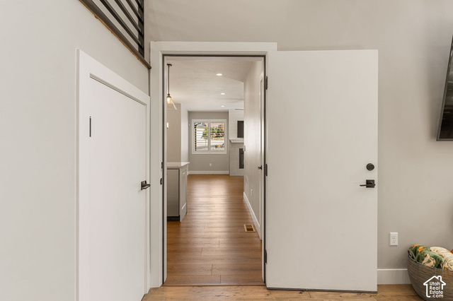 1192 East Ashdown Road Cedar City, UT 84721 - Photo 49 of 96 Wood-finish flooring, white doors with matte black hardware, and an open doorway leading to a brightly lit room
