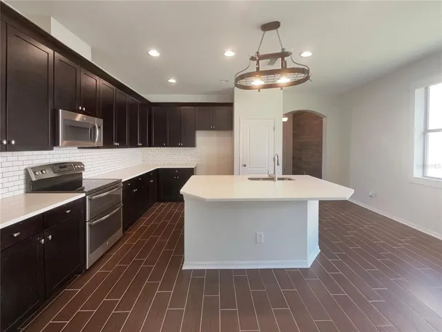 a kitchen with a sink and chandelier