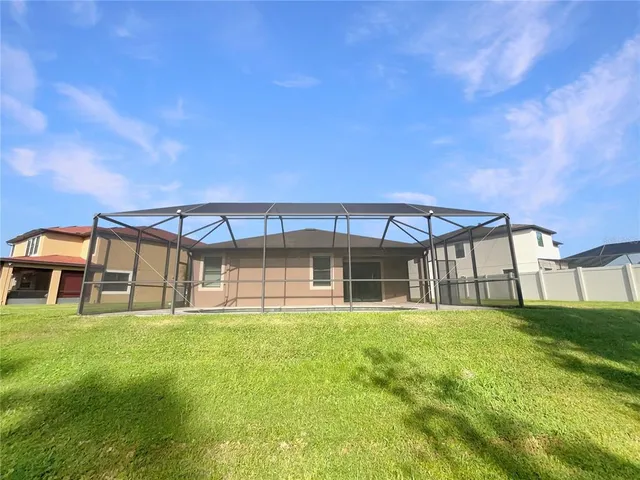 a view of a house with a yard and sitting area