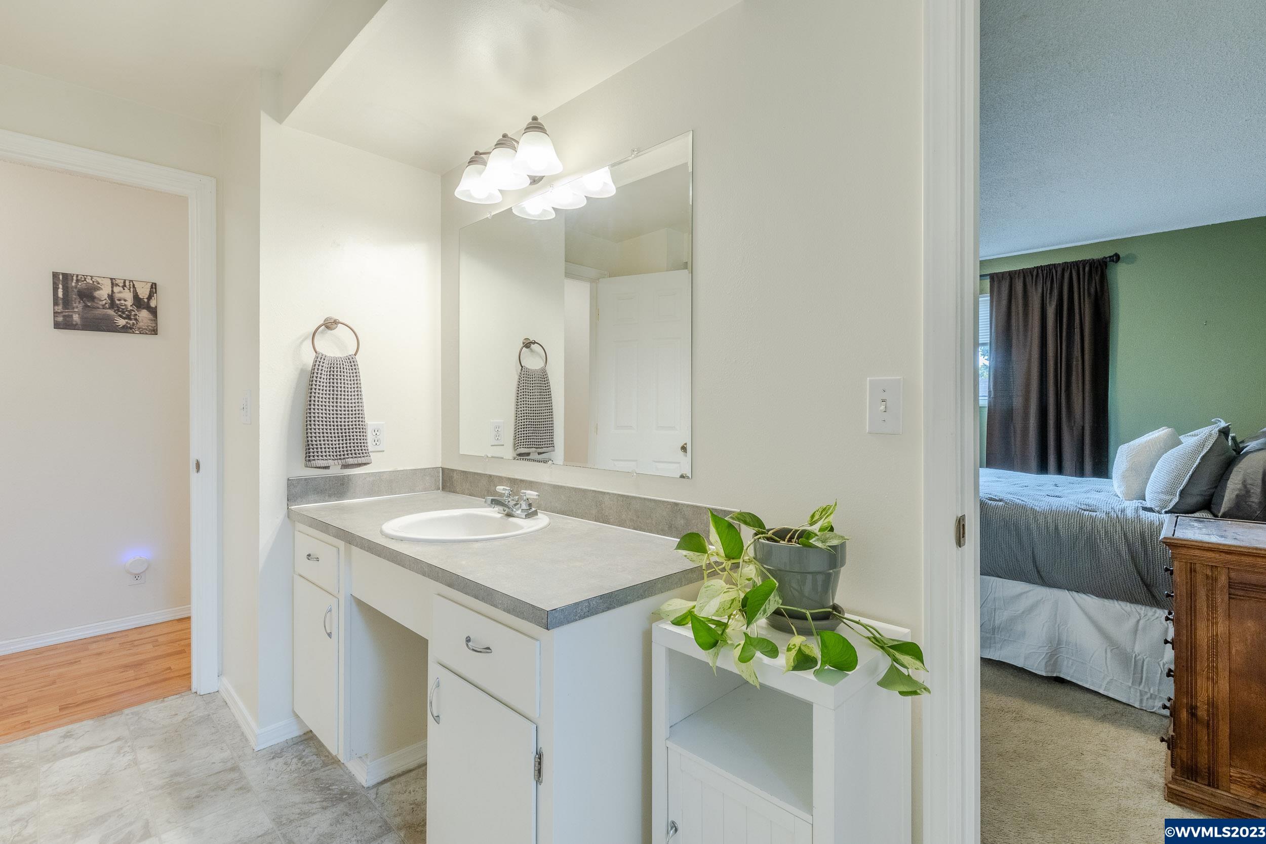 2136 15th Street Springfield, OR 97477 - Photo 24 of 38 a bathroom with a sink vanity and a mirror