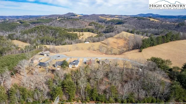 an aerial view of mountain with wooden fence