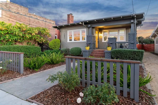 a view of a house with brick walls and potted plants