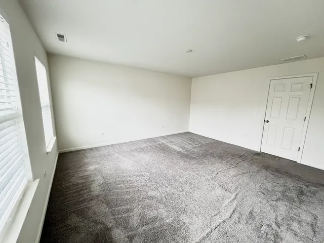 a bathroom with a granite countertop toilet sink and mirror