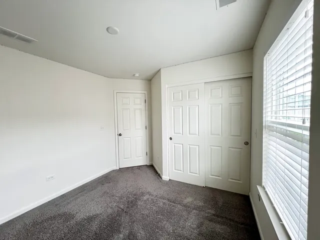 a kitchen with stainless steel appliances a stove a refrigerator a sink dishwasher a dining table and chairs with wooden floor