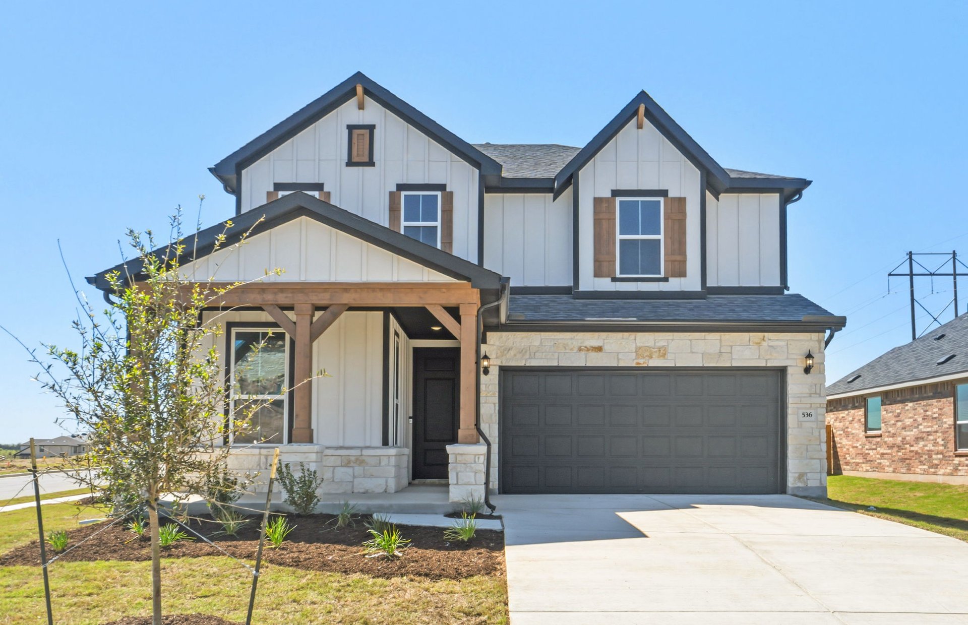 536 Rubber Tree Way Buda, TX 78610 - Photo 1 of 32 a front view of a house with a yard and garage