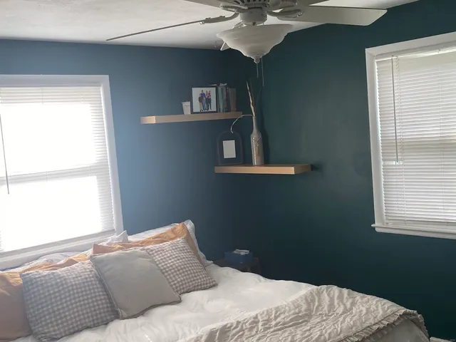 a bedroom with a bed and window