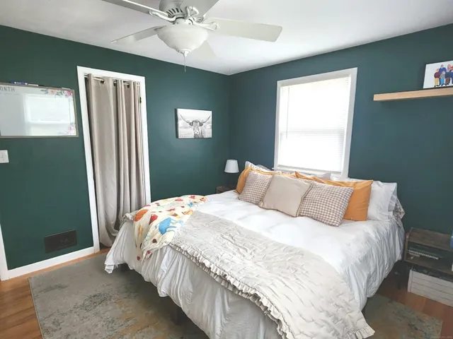 a bedroom with a bed and a window