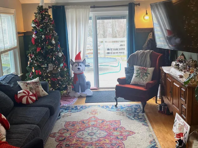 a living room with furniture and a christmas tree