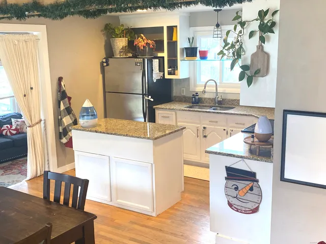 a kitchen with stainless steel appliances granite countertop a refrigerator and a stove top oven
