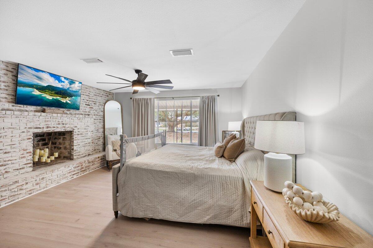 1011 Creel Street Fort Walton Beach, FL 32547 - Photo 11 of 30 a bedroom with a bed and a fireplace