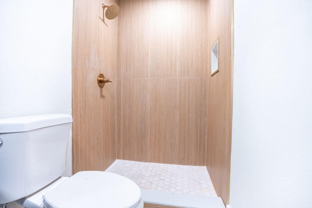 1011 Creel Street Fort Walton Beach, FL 32547 - Photo 15 of 30 a bathroom with a toilet and a shower curtain