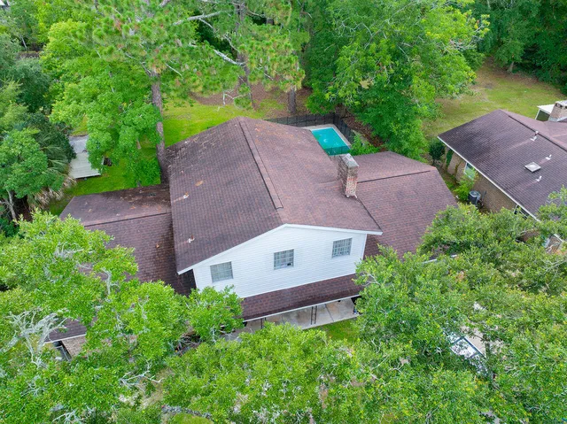 an aerial view of a house with a garden and a yard
