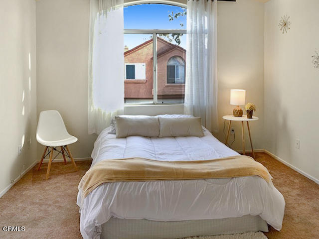 1217 Nautical Way Oxnard, CA 93030 - Photo 12 of 15 a bedroom with a bed and a chair