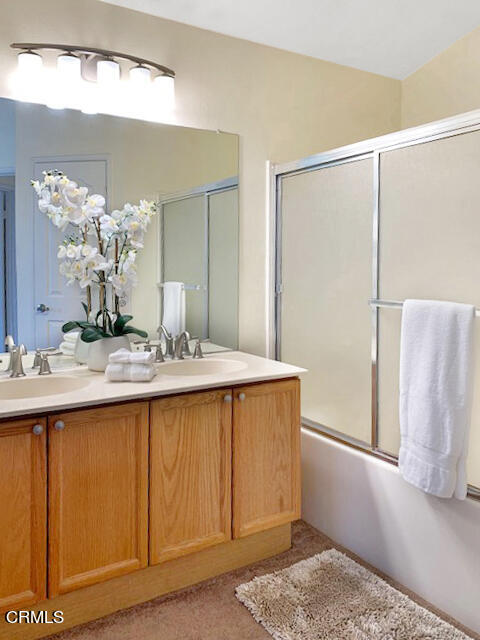 1217 Nautical Way Oxnard, CA 93030 - Photo 13 of 15 a bathroom with a granite countertop sink and a mirror