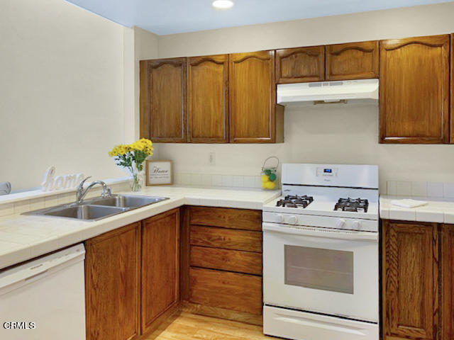 1217 Nautical Way Oxnard, CA 93030 - Photo 6 of 15 a kitchen with a sink stove and cabinets