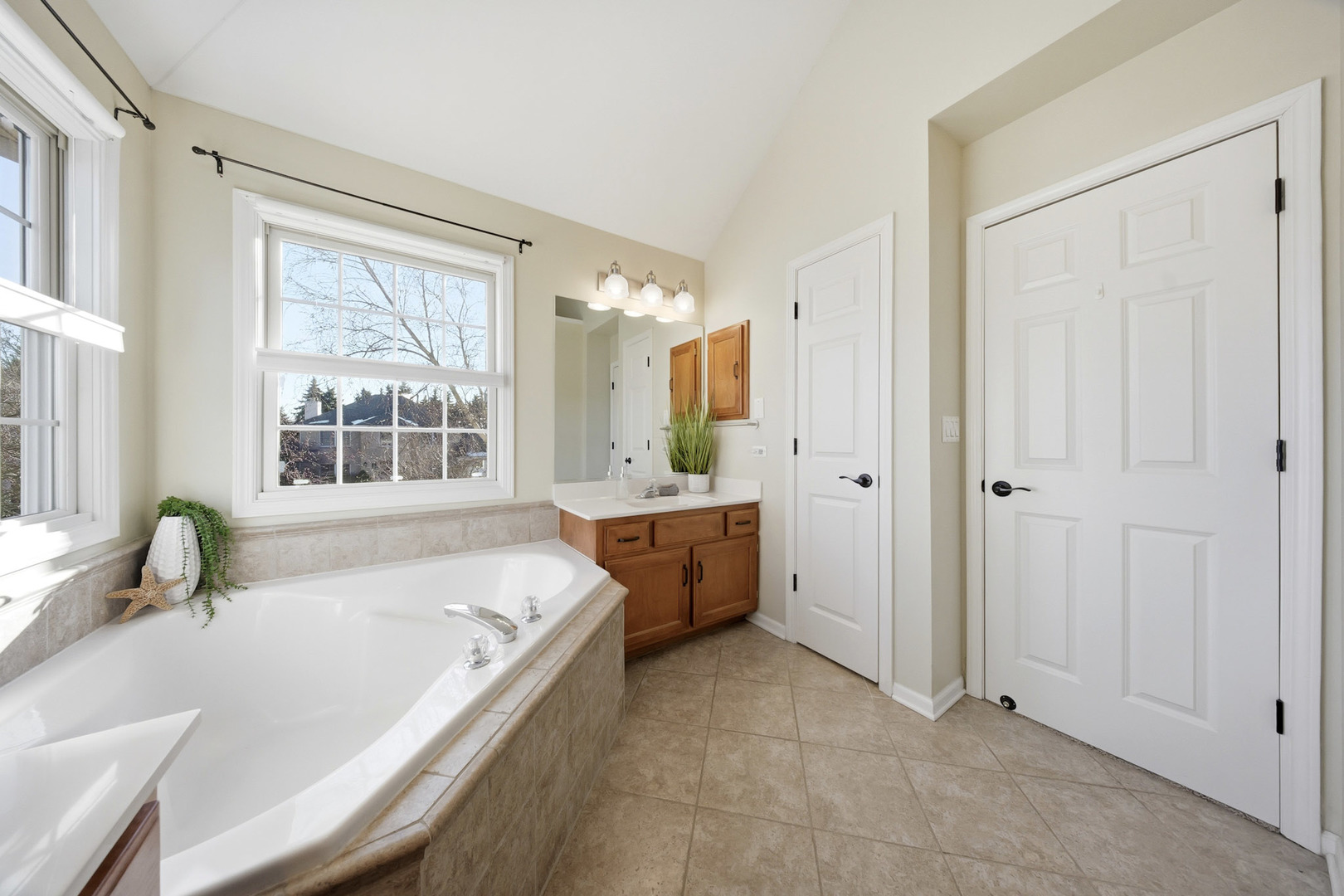 548 Arbor Lane Oswego, IL 60543 - Photo 23 of 46 a large white tub sitting in a bathroom next to a window