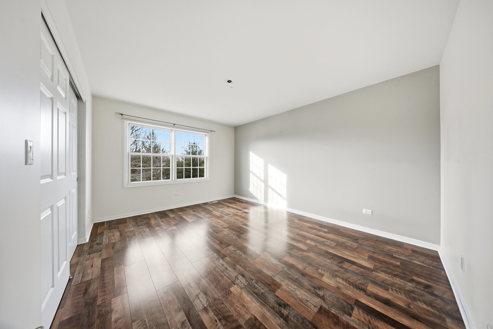 548 Arbor Lane Oswego, IL 60543 - Photo 28 of 46 a view of an empty room with wooden floor and a window