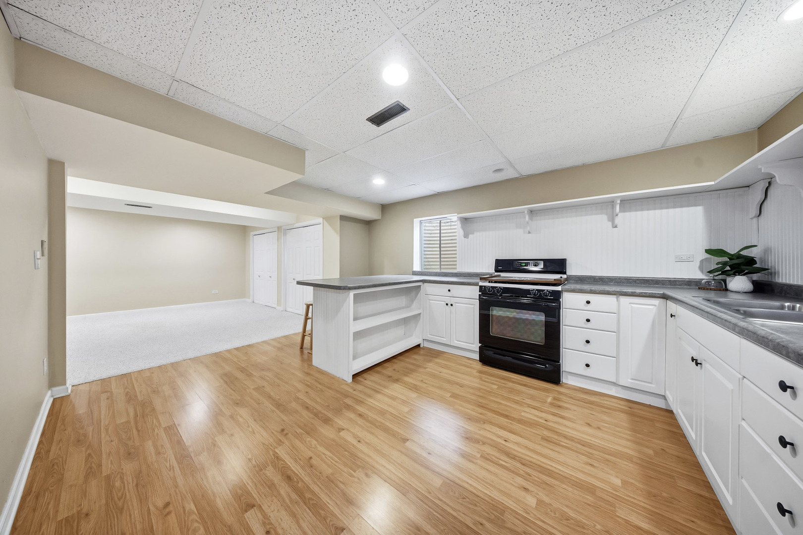 548 Arbor Lane Oswego, IL 60543 - Photo 32 of 46 a kitchen with granite countertop a refrigerator and white cabinets