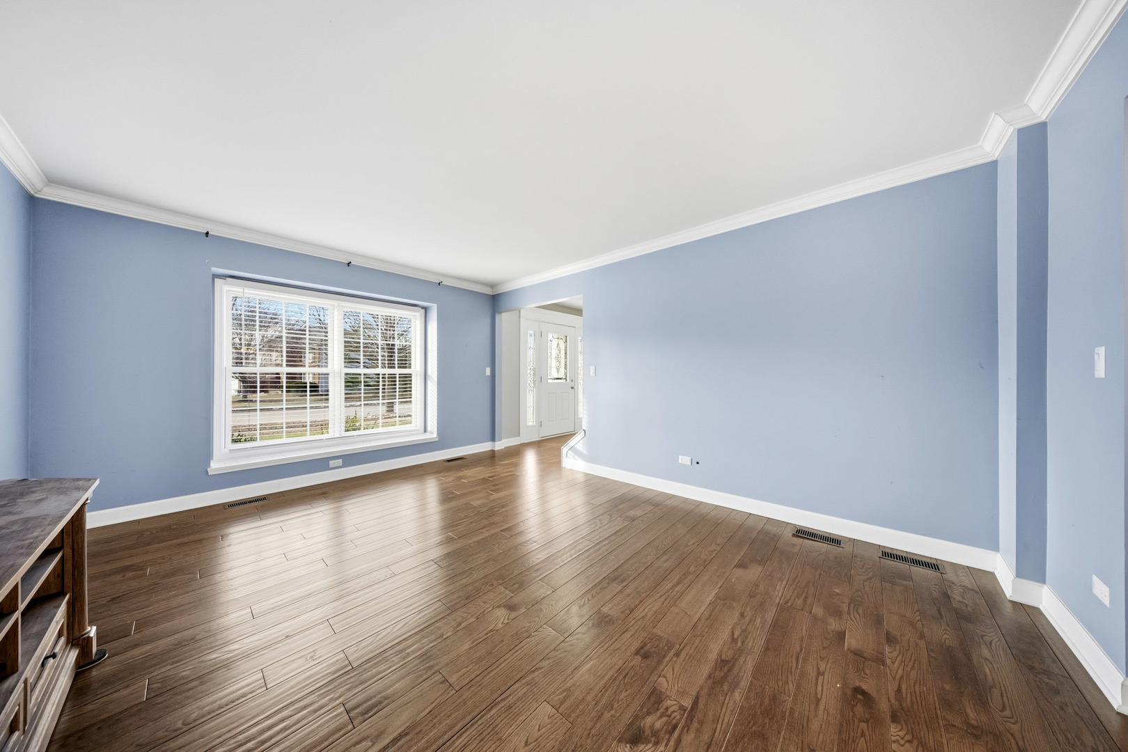 548 Arbor Lane Oswego, IL 60543 - Photo 7 of 46 a view of an empty room with wooden floor and a window