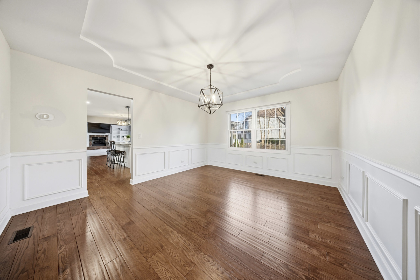 548 Arbor Lane Oswego, IL 60543 - Photo 9 of 46 an empty room with wooden floor chandelier and windows