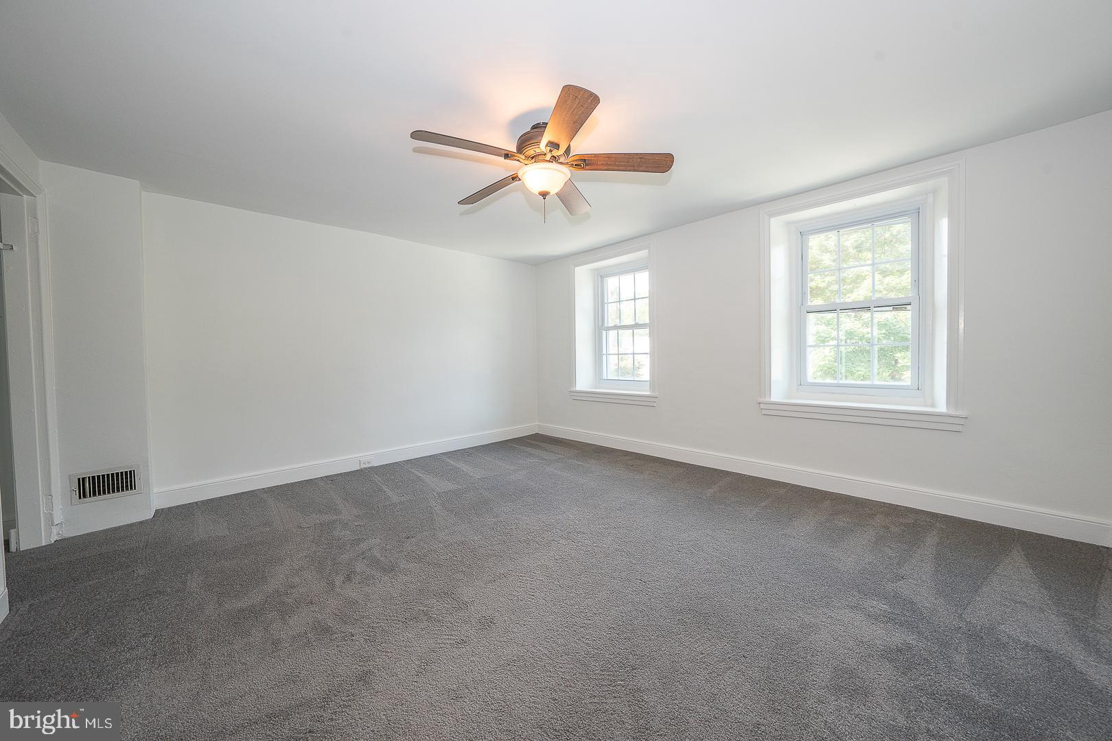 312 Highland Road Cheltenham, PA 19012 - Photo 17 of 36 an empty room with windows and fan