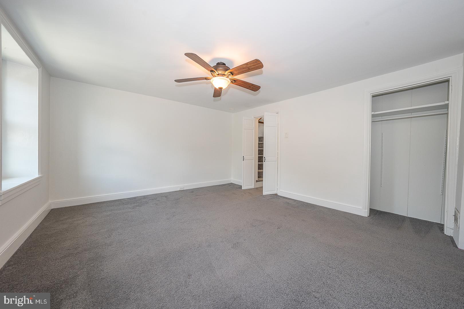 312 Highland Road Cheltenham, PA 19012 - Photo 18 of 36 an empty room with a window and a ceiling fan