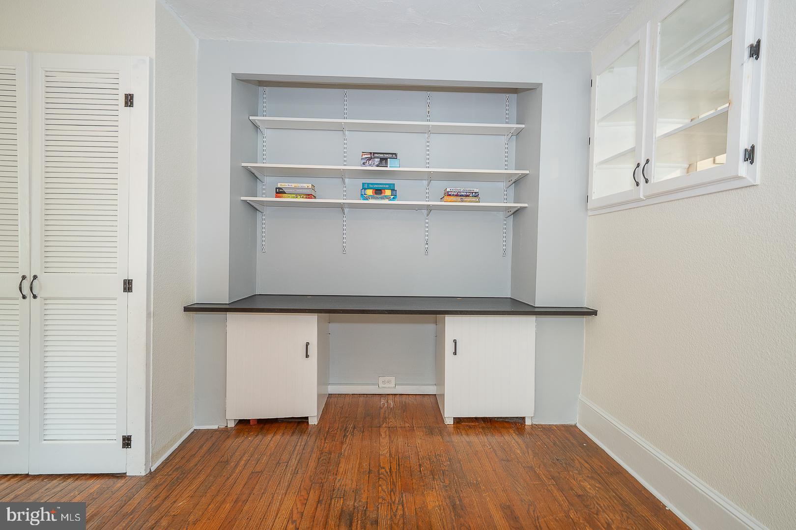 312 Highland Road Cheltenham, PA 19012 - Photo 8 of 36 a room with a wooden floor and cabinets