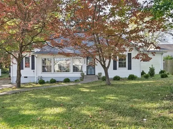 a house view with a sitting space and garden