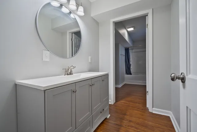 a spacious bathroom with a double vanity sink and a mirror