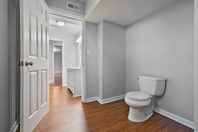 a bathroom with a toilet and a mirror