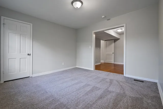 a view of an empty room with closet area