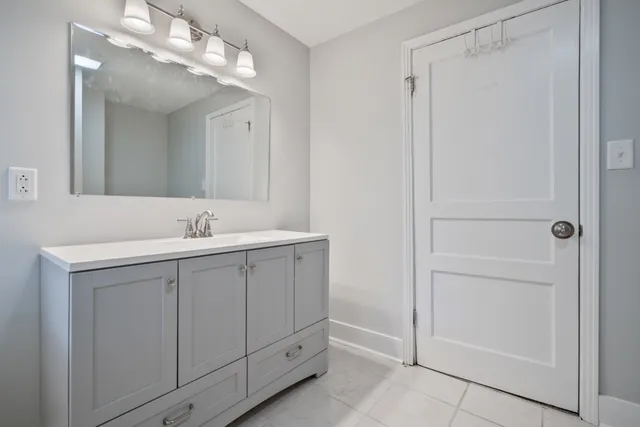 a bathroom with a double vanity sink and a mirror