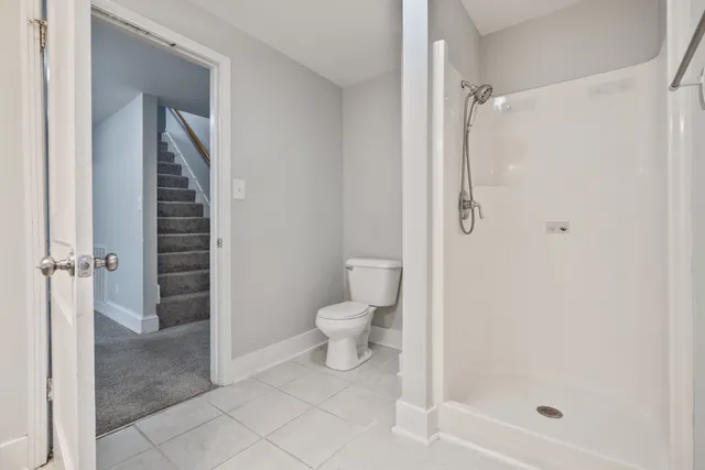 a bathroom with a shower and a toilet
