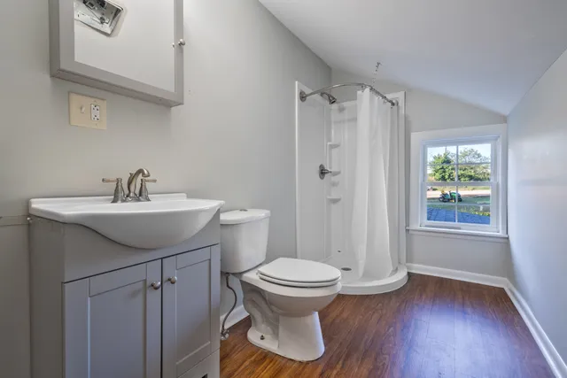 an empty room with an entryway and fan