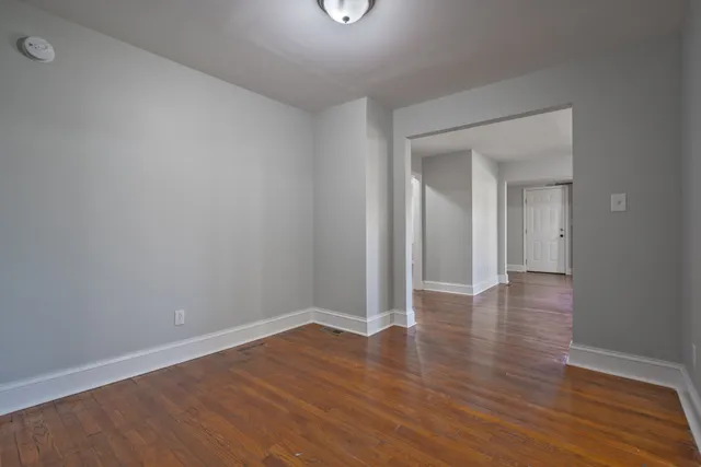 a view of a room with wooden floor