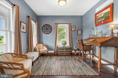 a large kitchen with stainless steel appliances granite countertop a lot of counter space and wooden floor