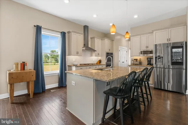 a bedroom with a bed couch and a window
