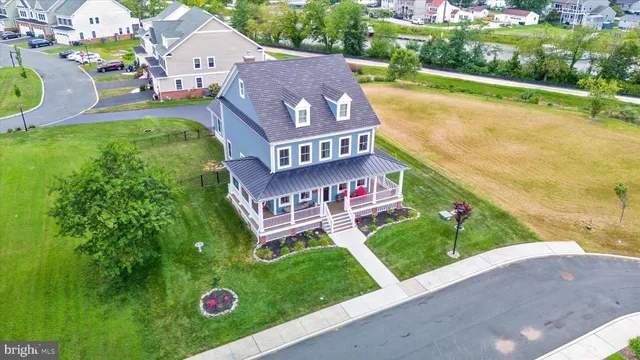 a view of a house with a yard and potted plants