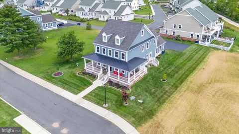 an aerial view of residential houses with outdoor space and swimming pool