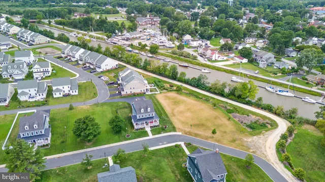an aerial view of a house with a yard and lake view