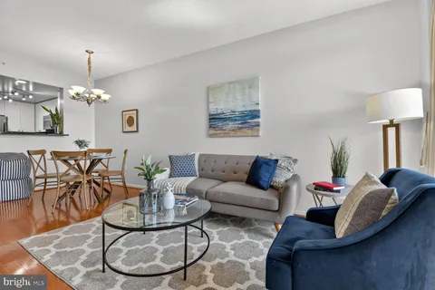 a living room with furniture and a chandelier