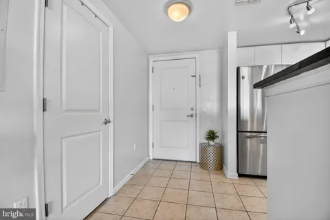 a view of a kitchen with refrigerator and car parked