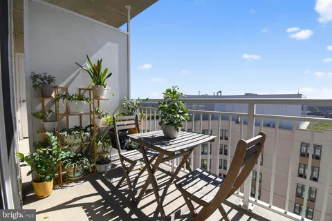 a balcony with table and chairs