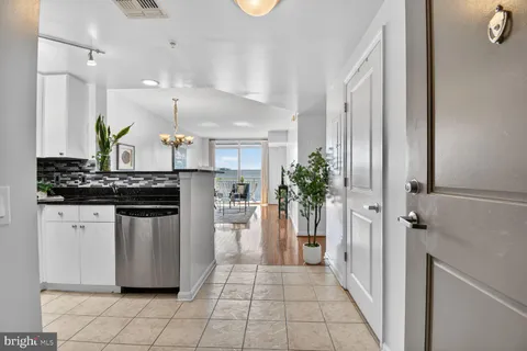 a kitchen with stainless steel appliances kitchen island granite countertop a refrigerator and a sink