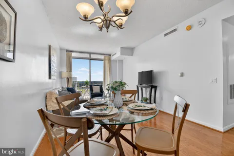 a view of a dining room with furniture window and wooden floor