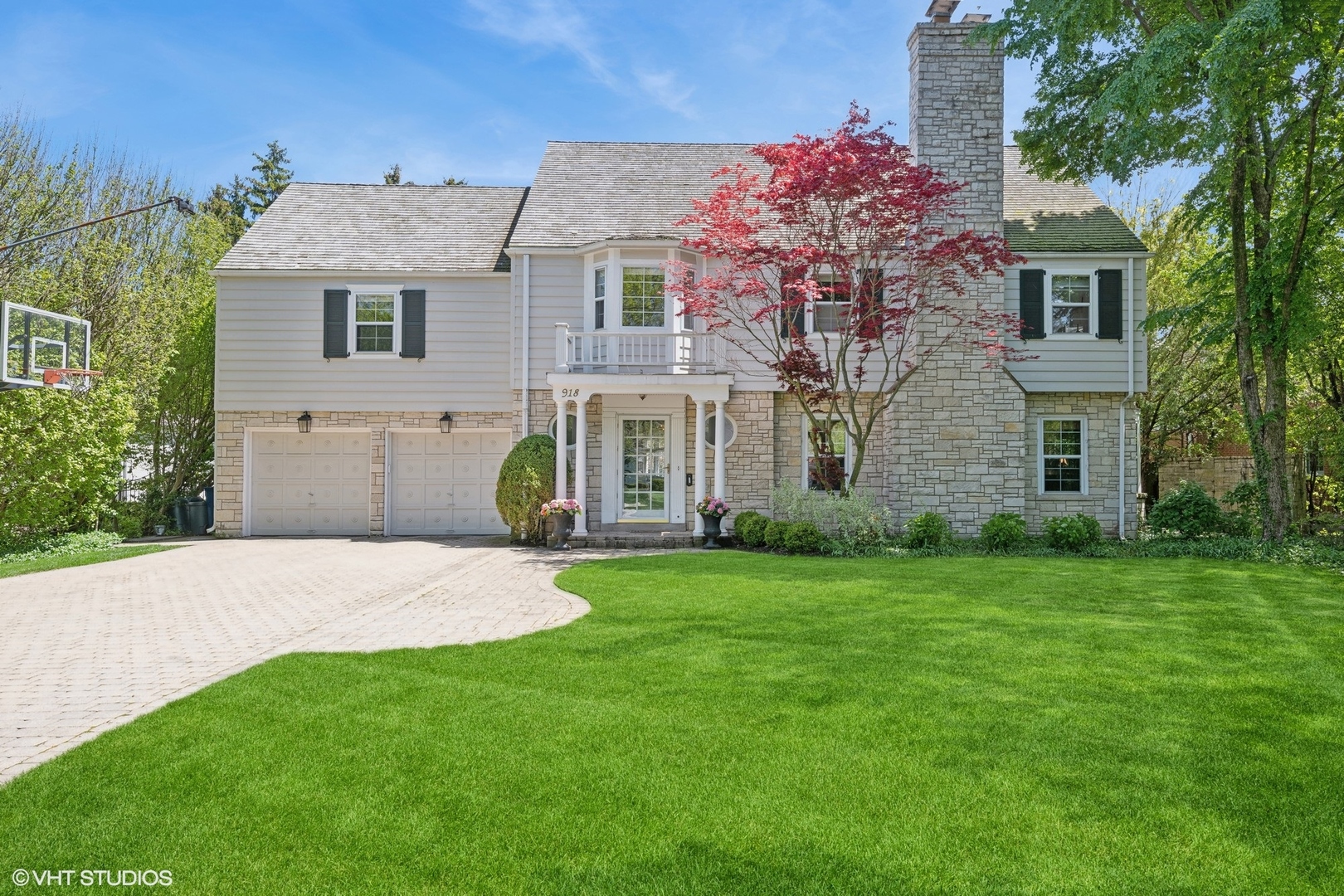 918 Locust Road Wilmette, IL 60091 - Photo 1 of 35 a front view of a house with a garden