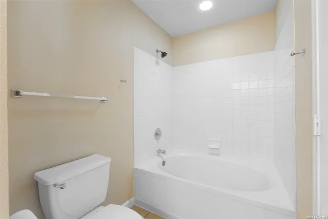 a bathroom with a toilet and a bathtub