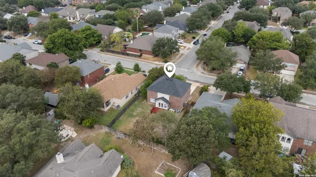 an aerial view of a house with a yard