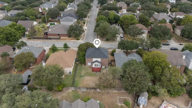 an aerial view of a house with a yard and lake view